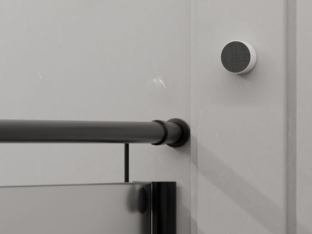 Bathroom render of a round fabric-covered device mounted on the wall beside a shower rail